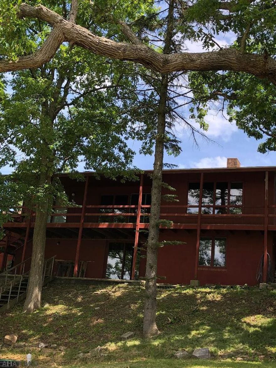 Panoramic views highlight this property.  Large Andersen windows provide bountiful natural light throughout  the main floor of this ranch home.  Three bedrooms and two baths on main level.  Kitchen has two year old range and refrigerator and leads to a spacious deck for summer entertaining.   Large living room, formal dining room with built-in display shelves and storage cabinets.  Hardwood floors throughout the house.  Both full baths have been updated . The  basement level has been finished into a huge family room with wood burner, a bedroom, 1/2 bath, storage rooms.  Here you will find almost brand new Samsung washer and dryer which is included.   Living room  woodburning fireplace chimney is capped.  No commission paid on sellers assist.  Buyer to verify taxes and sq. footage.