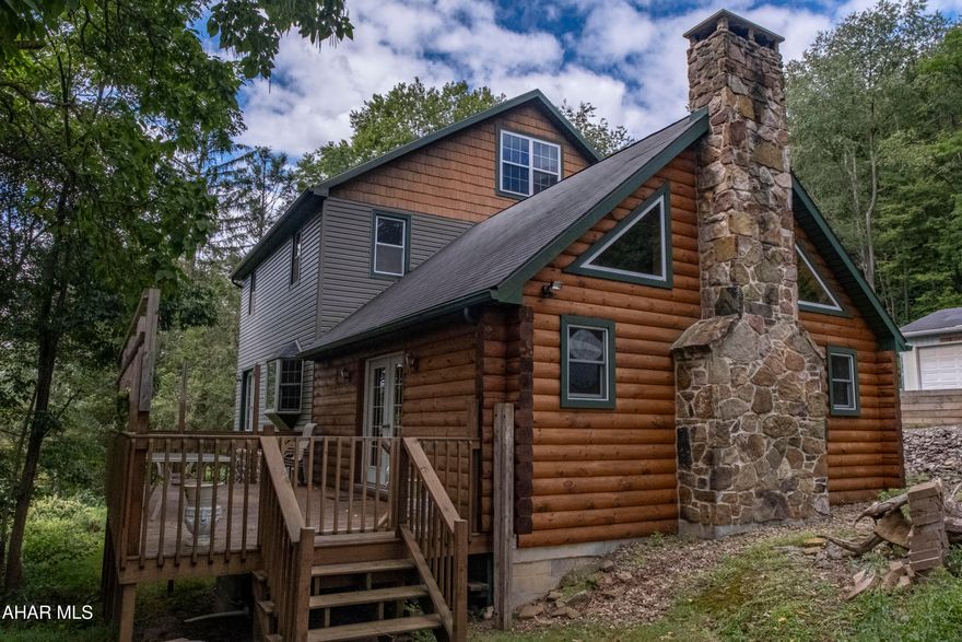 Nestled in a tranquil, wooded setting just minutes from Johnstown's cultural district, this striking two-story home delivers a perfect blend of rustic charm and modern convenience. The custom log family room features a vaulted ceiling with a loft- evoking a cozy lodge-like ambiance ideal for relaxation and entertaining.

Spanning 2,632 sq ft across 5 bedrooms,  2.5 bathrooms, and a fully finished-heated attic that  can be used as a possible 6th bedroom, the home boasts thoughtful touches throughout, including a luxurious main-level bathroom with a spa-like jacuzzi and a custom redwood slab vanity imported from California - truly a unique statement piece. Beautiful woodwork flows throughout the interior, complemented by a convenient second-floor laundry, multiple bonus rooms, and a versatile finished attic space.

A full basement workshop provides excellent space for hobbies or storage. The heated two-car garage with 10-foot ceilings allows for year-round projects and easy-access vehicle storage. Outside, enjoy a covered porch, deck, and patio - all set on nearly one acre of lush land, offering plenty of privacy and outdoor enjoyment.

Spacious and serene, this one-of-a-kind retreat combines craftsmanship, functionality, and woodland solitude in one beautiful package!

Contingent upon seller finding suitable housing.