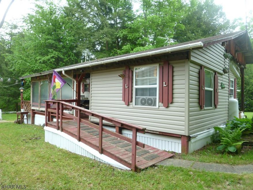 More for your money!  Remodeled park model camper with additional bedroom offers lots of room for the whole family to sleep, cook and eat.  Full size appliances including a new water heater.  One bed has a Serta mattress and is temperature controlled.  Bath is handicapped accessible.  Large covered deck allows you to be outside regardless of the weather.  The shed will hold your tools and toys.  Heat is forced air but there is also a wall heater in the kitchen.  Furnace needs a pilot light.  Property is located in Glendale Yearound, a gated recreational community adjacent to Prince Gallitzin State Park / Glendale Lake.  Only six miles from Rock Run ATV Park.