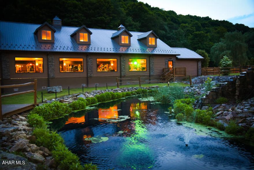 Designed and custom built in the rolling hills of Central PA. This Estate offers a once in a lifetime opportunity to own a extremely established and well known wedding Resort which average's over $250,000 in revenue a year including this 2026 season and booking 2027. This rare opportunity is a Turn-key operation with management, staff, equipment, advertising, and sales in place and operating. The Estate sits on 39.23 acres with a rolling stream, two covered bridges, a waterfall, hiking trails, decorative pond, and a stone vehicle bridge. The Estate offers multiple structures including: Main House, a 4900 sq ft (gross living area) main residence which offers a granite gourmet kitchen, a large great room with custom fireplace, custom dining room, 3 bedrooms, 2 ½ baths, large walk in closet, a game room, movie theater room, weight room, office and a 2 & ½ heated car garage; Whispering Lodge, a 5000 sq ft custom built reception hall that can hold 260 guests, custom dance floor, elegant built in bar, 800 sq ft prep room, custom large restrooms, a 1600 sq ft covered patio that includes a custom bar, brick oven pizza oven and covered ramp with loading area for vendors; Whispering Cove Cottages, six (6) beautiful custom built intimate cottages with all amenities, 420 sq ft with full baths, heat, A/C Queen Bed and Living area; The Barn, which offer a 2-story Bridal room with a Living room, Make-up room, Kitchen, Master bedroom, Hair salon, 1 & ½ baths. Lots of designed storage on multiple floors, a plumbing room, employee restroom, drive through golf cart charging garage and four stables. The barn also has a 24 x 50 covered carport into the parking lot; Maintenance Shop which is a 896 sq ft shop with heat and a 20x20 covered carport for a car wash; The Gift shop, 380 sq ft cottage for cottage check-in and sales; The Chalet is a secluded 1200 sq ft located deep in the woods, one bedroom, loft, kitchen, full bath, and living room with custom fireplace; Rolling waters courtyard is a 40x140 ceremony location tucked into the hillside for hosting wedding ceremonies or live entertainment. If you have always wanted to own a wedding resort this is a truly once in a lifetime opportunity to purchase a complete operation which is producing revenue as is.