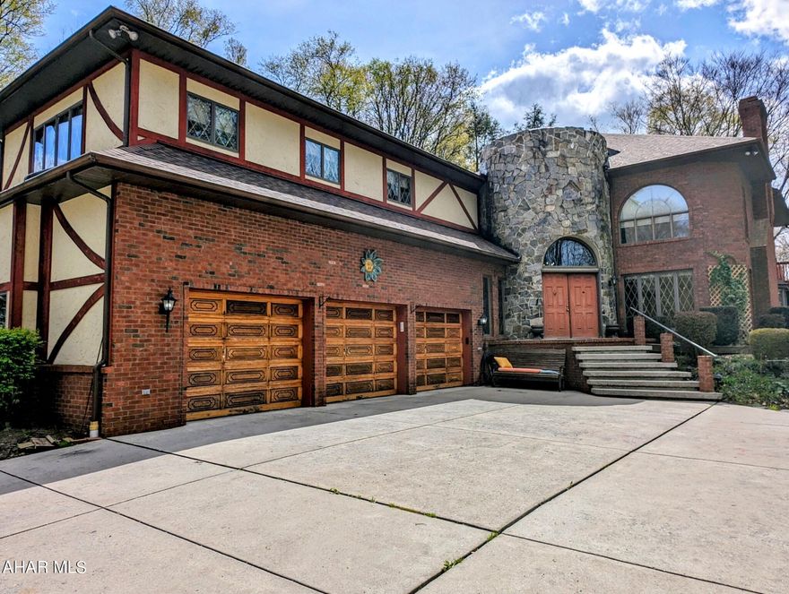 This absolutely stunning English Tudor, situated on a private 11+ acres, is calling you home!  A winding private drive through the woods welcomes you to this one of a kind home.   Boasting over 6,000 sqft of finished living space this home has plenty to offer every buyer.  The front entrance takes you through the 2 story stone turret foyer and into the main living areas.  The heart of the home lies in the expansive living room, where a grand stone fireplace serves as a focal point for gatherings.  A gourmet kitchen overlooks the living room, with granite counter tops, counter seating, subzero refrigerator and freezer, wall ovens and induction cook-top.  Adjacent, the formal dining room is ideal for having the entire family over for dinner. After dinner there is more fun for everyone with the finished lower level bar and game room, perfect for entertaining. Retreat to the spacious master suite, featuring an over-sized soaking tub, large tile shower and dual separate vanities and walk-in closet.  Each additional bedroom offers ample space for family and guests, each thoughtfully appointed and with generous closet space.  A large 3 car attached garage offers plenty of parking and even more space is available for your extra toys in the detached 4th garage bay.  Enjoy comfort and efficiency with geothermal heat pumps, multiple backup heat sources as well as a brand new roof with transferable warranty.  Outside there is so much to offer, with gorgeous wooded views from multiple decks, flowering trees, gardens and more.  A truly special property that is waiting to be your next home!