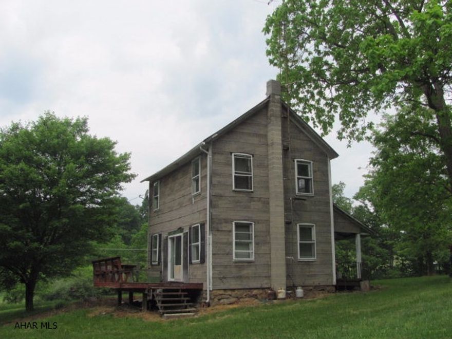 This is a residence that needs some TLC but is setting in a great location. This would make a great hunting lodge for the boys and his buddies. The residence sets on 6 or 8 flat acres of grass and the drive way crosse through a small hayfield about 150 yards off of the main highway. The thirty or more acres behind the home is tree covered and is great ridge in the middle of great hunting territory. Thre is  a small stream at the front edge of the property. The lane is in good shape and easy to acess from the main road. There is plenty of flat acerage for your buddies to park an RV/Camper or tent and enjoy the luxury of a private well and sewer. The lot also has a pole building for storage of equipment and  for taking care of your game after the hunt. State game lands surround the area.
