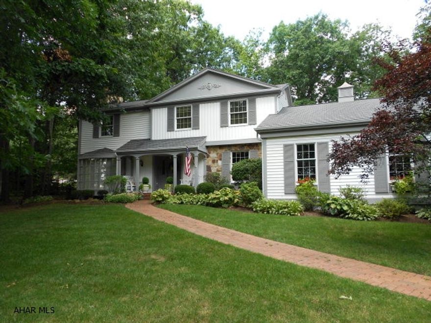 Custom designed home built with quality materials and workmanship. The interior is decorated with design features including grand spiral staircase, crown molding, finished wood trim, chair rail, and quality flooring (hardwood, slate & ceramic tile); four fireplaces, one in each of the 2 master bedrooms, formal living room, and family room. The first floor features a large master bedroom, master bath with skylights within walk-in closets, vaulted ceiling, sitting area with mirrored wall. A stunning sun room with a hot tub, pella windows and skylights. The custom kitchen has oak cabinets, marble counter tops, stainless steel upscale appliances.  Private paved patio area. Second floor offers a master bedroom/bath suite, three bedrooms, one full bath. Basement is finished. MUST SEE! MANY EXTRA