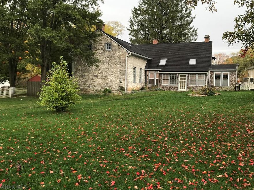 This stunning historic stone home has been impeccably restored from the wide plank wooden floors to the oversized handcrafted front door.  Original structure was built in the late 1700's. Kitchen has a fp along with a large hearth w/woodburning stove. There's also an island with prep sink and all appliances are included. Living room features built-in bookcases, wet bar, and fp. DR can accommodate those large family gatherings and add to the mood with another fp. Each bedroom has it's own bath. The den has an office area and a door to the fenced yard. Courtyard with privacy fence The new 2 bdrm raised rancher is included with this property or could be garage w/apartment. Each home can be purchased separately. What a perfect B&B! Adjacent to Rails to Trails and kayak launch nearby.