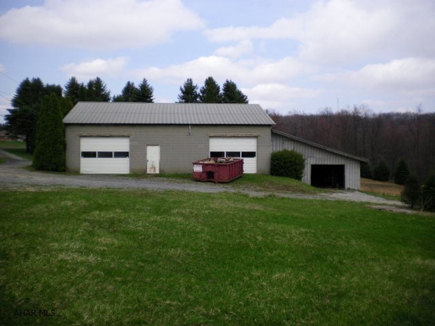 Endless possibilities with this 3.4 acre property with large 51 X 41 foot block garage with shed off the back.  Evergreen trees cover a large portion of this property.  No Zoning and No sewage at this time.  Water is available on the properties side of the road, but no tap is present and sewae maybe available in the near future-as per Mike Pisarcik Manager of Blacklick Twp. Water& Sewar Dept 814-749-0276.