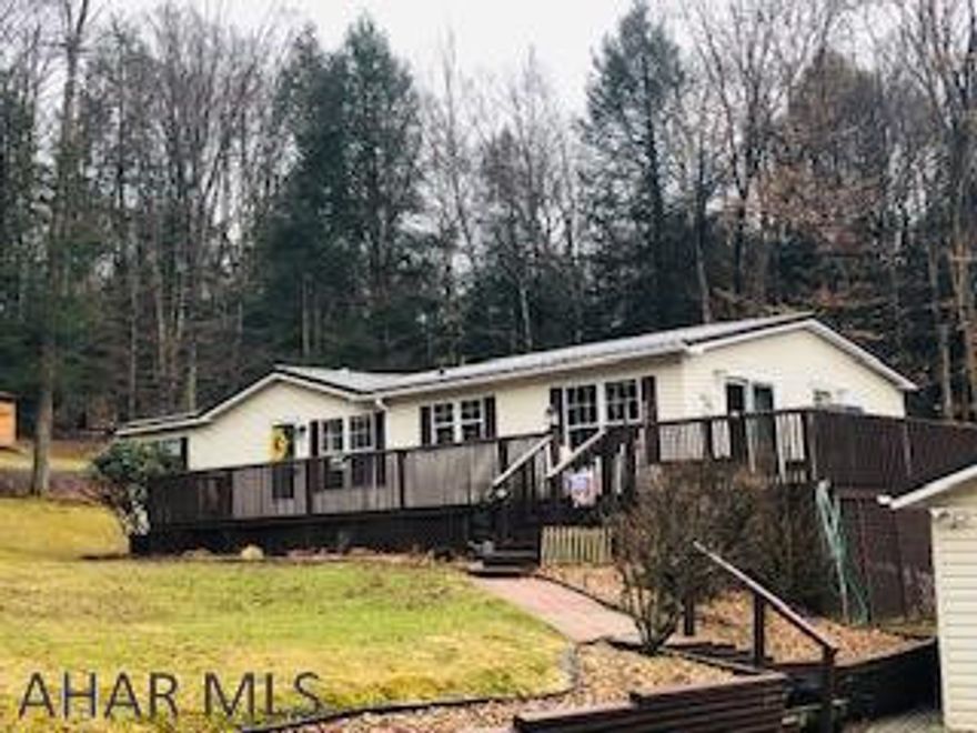 Very well maintained one level home on an acre of ground tucked back off the main road.  Enjoy the advantages of living in the woods watching the deer and other wildlife while experiencing the perks of living in a gated community.  Master suite is separated from two other bedrooms, which have their own full bath, by the living room / foyer area.  Island area in the kitchen adds extra work space for cooking while the desk area allows you to work from the heart of your home.  Laundry is off the kitchen.  Atrium at the rear of the home gives you space to try out your green thumb or add a hot tub for relaxing.  Two car detached garage with lots of storage space or room for a workshop.  Community pool, tennis/basketball/volleyball courts, club house, dog park.  Adjacent to Glendale Lake.