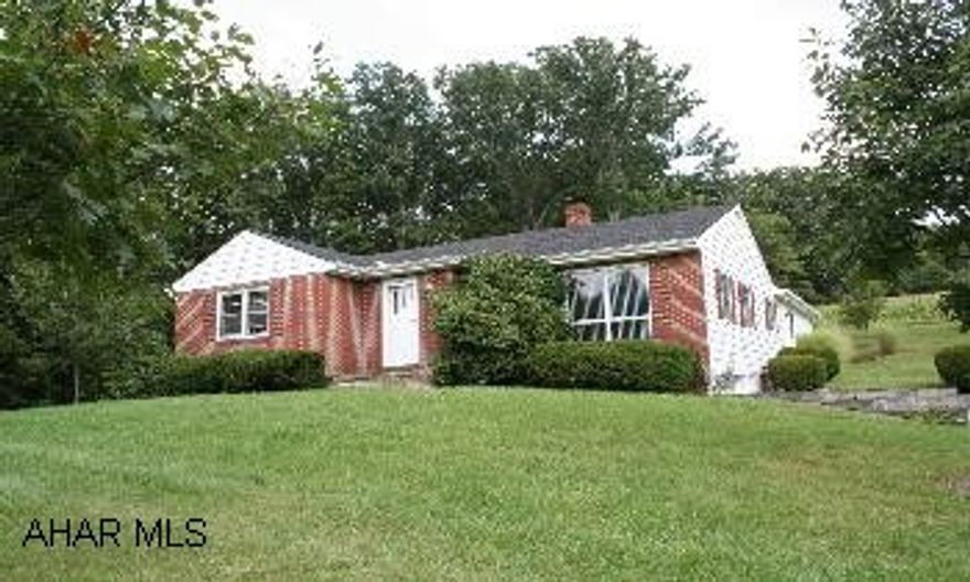 Charming brick ranch home in perfect setting, large yard w/woodland views. Private setting, close to hospital. Views of the mountains, many trees. Basement level has laundry, open room, workshop, and garage. 12'x28' outbuilding w/electric, cable and phone.
