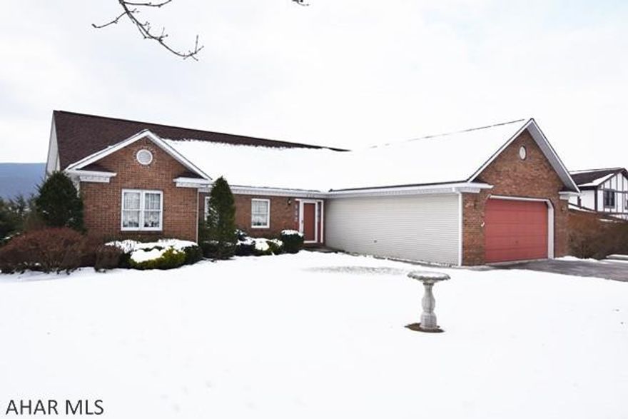 This house has so much to offer, including one of the best views in Hollidaysburg!  You will love the spacious, open floor plan.  There are gas fireplaces in the living room and lower level family room.  Finished basement has wet bar, 3/4 bath,  and a fully equipped Summer kitchen.  Basement also has large work space for hobbyist. Central air.   Covered rear porch, large deck.  Oversized two car attached garage.