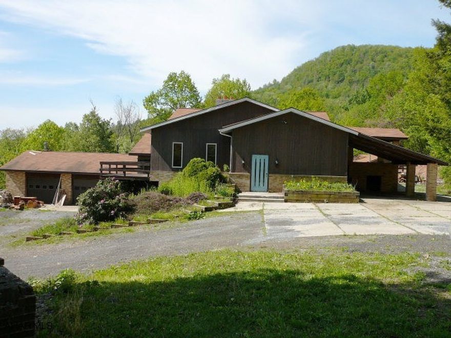 Investors! Three bedroom, three bathroom one story on 2+ acres.  Large 2 car garage.  Smaller pole barn structure(pavilion, no walls).  Deck, patio, and more. SOLD AS IS. Financing: cash.  Great setting.  Needs work. Primary heat source - wood stoves. Talk with listing agent for more information.