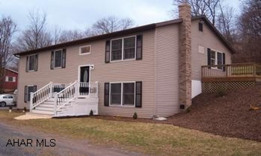 raised ranch home with 2 car integral garage. Raised ranch home with 2 car integral garage and professionally landscaped yard. Located in a quiet neighborhood of Bedford with scenic views. Features 3 bedrooms, oak kitchen, anderson windows, large wrap around deck, masterbath with tiled walk in shower, main bath has a tiled surround, open floor plan, finished basement with separate laundry room and also a separate 1/2 bath. This home has been freshly painted and has new carpet and vinyl.