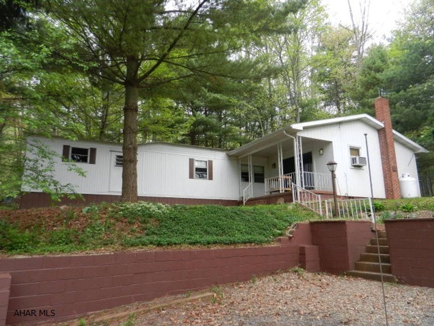 Privacy is a premium at this weekend retreat on a mostly wooded 1 acre lot.  2 bed 1 bath with additional living room with wood stove.  Within 30 min of Lake Raystown boat launches, Breezewood turnpike exit, and excellent public hunting property.  A variety of wildlife surround the property, detached shed.  A little TLC and could be a wonderful retreat for years to come.