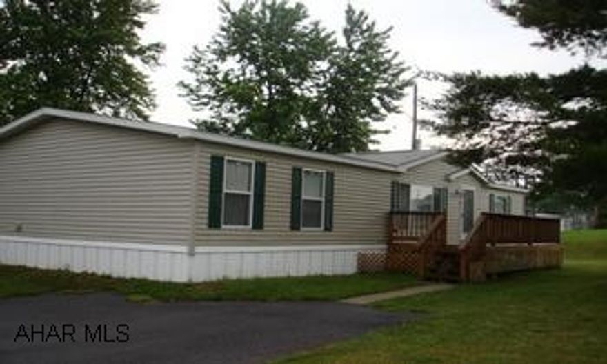 Lovely 2003 three bedroom double wide on rented lot.  Large master bathroom with garden tub. Dining area, laundry room, two baths.Two refrigerators, range, dishwasher, microwave, washer, dryer, wide screen television in entertainment center included.   Great one story living.  Range, two refrigerators, dishwasher, washer, dryer, microwave,  Heat is kerosene. Lot rent is $180. per month. (Includes garbage)