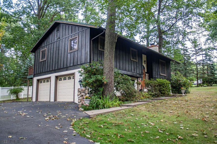 Looking for a beautiful, quiet, scenic home? Well this home has all that and more! This Bi-level home sits perfectly on an approx.1/2 acre lot w/ tall trees throughout. The main level has an open concept floor plan. A gas fire place w/ large stones accents the living room to give it a cabin feel. The eat-in kitchen features granite counter tops, recessed lighting, and newer cabinets.. Sliding glass doors in the dinning room take you to the lovely deck that wraps the back of the house. The full bathroom is spacious and has a double vanity! Master bedroom also has sliding glass doors to access the deck. Don't need the additional bedrooms? Perfect for office, gym equipment, or powder rooms!  Finished basement can be turned into a Master Bedroom and has a 1/2 bath. HOME WARRANTY INCLUDED!