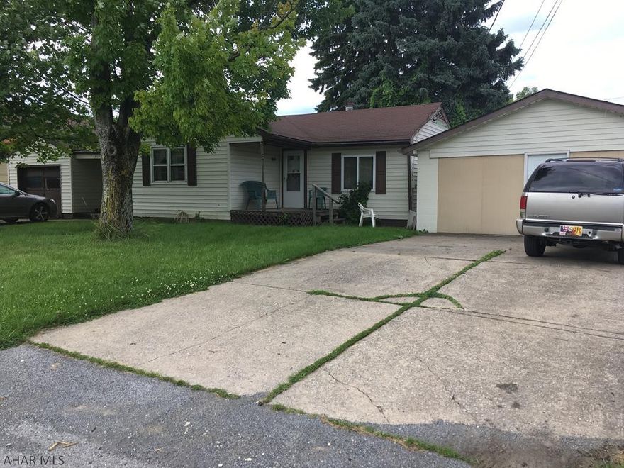 Ranch home with a detached one car garage and a 6 car garage currently used as an apartment. Great investment home with some TLC.