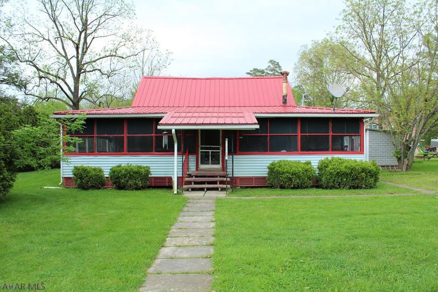 Maintained cottage in Camp Sunshine. New metal roof, completely screened in porch and a nice level yard. Enjoy relaxing sunrises and peaceful evenings in this 3 bedroom home with large family room with open ceiling.  Call today for a private showing.