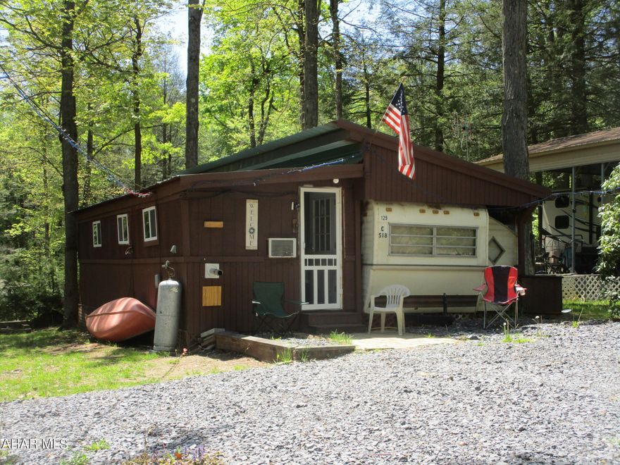 Are you looking for a camp with room for all, or a full time residence?  This property can be used for either.  The large comfortable living room is where you will spend time relaxing.  Two bedrooms and one bath.  Hookups for washer and dryer.  Seller has done many updates in the last two years:  new roof, remodeled addition, updated electric system, new water heater, added w/d hook ups and pellet stove.  Level lot and shed adds outside use.
Pellet stove and extra pellets in shed stay with a full price offer.