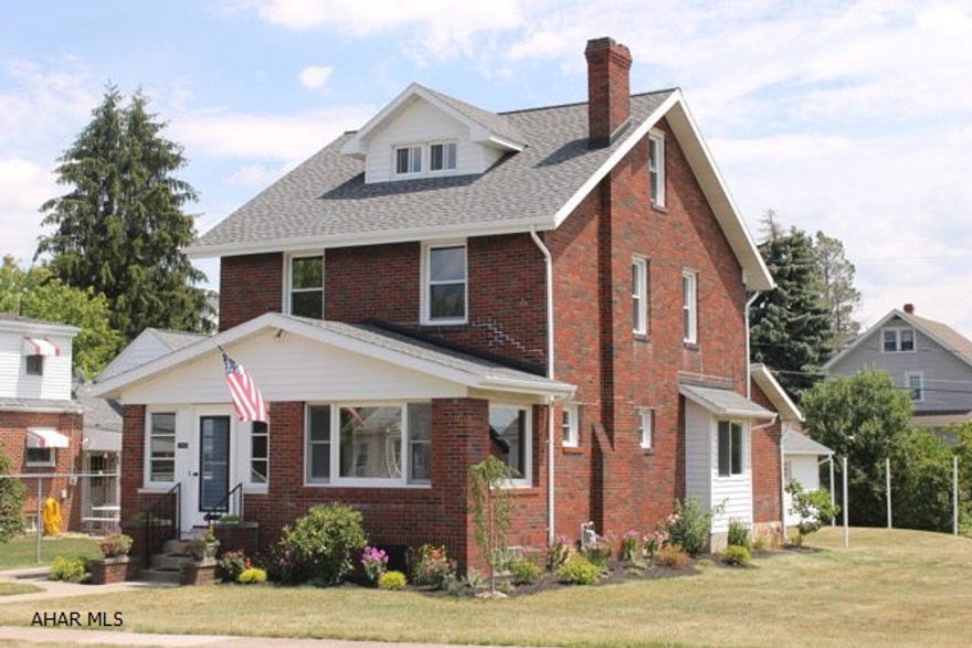 Beautiful brick home on a large flat lot. Spacious  living room and sunroom with hardwood floors.  French glass doors lead into the dining room and gorgeous full bath/laundry room. The kitchen has a quaint breakfast nook and a pantry/mudroom. The second floor has 3 bedroom, all with nice size closets, hardwood floors and original doors with glass knobs and a modern full bath. Finished attic for added space. 1 car detached garage with a covered patio for entertaining.