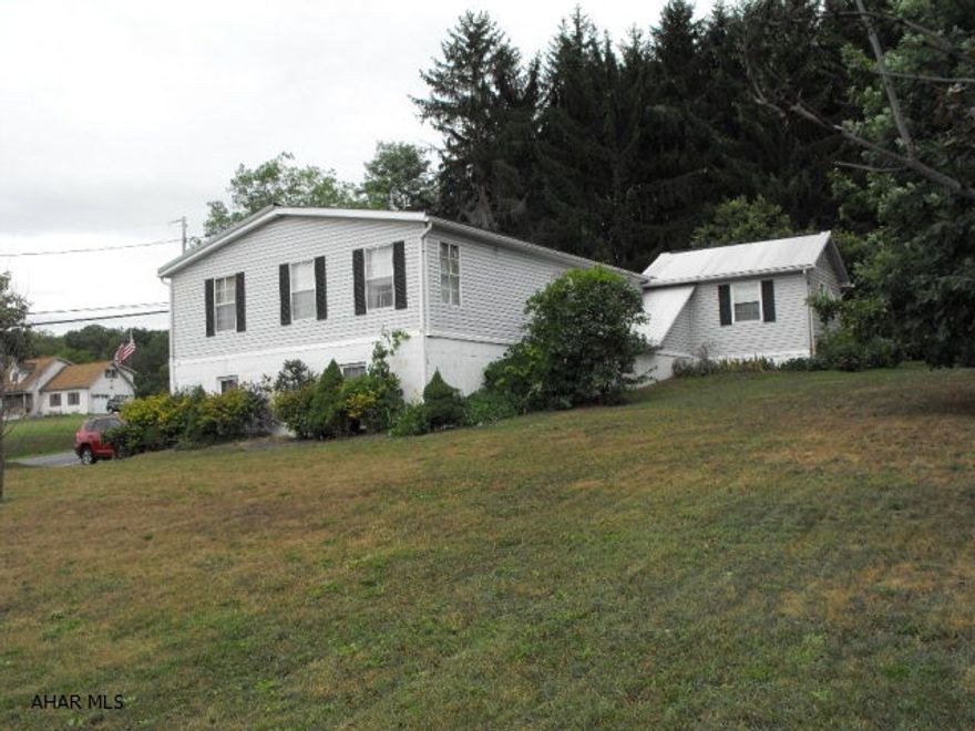Home in the country but only a few minutes away from the Chestnut Ridge Schools. Beautiful grove of trees beside house with a picnic area  fashioned in it to create a peaceful place to gather. Inside are many extra bonus areas with plenty of room to entertain.