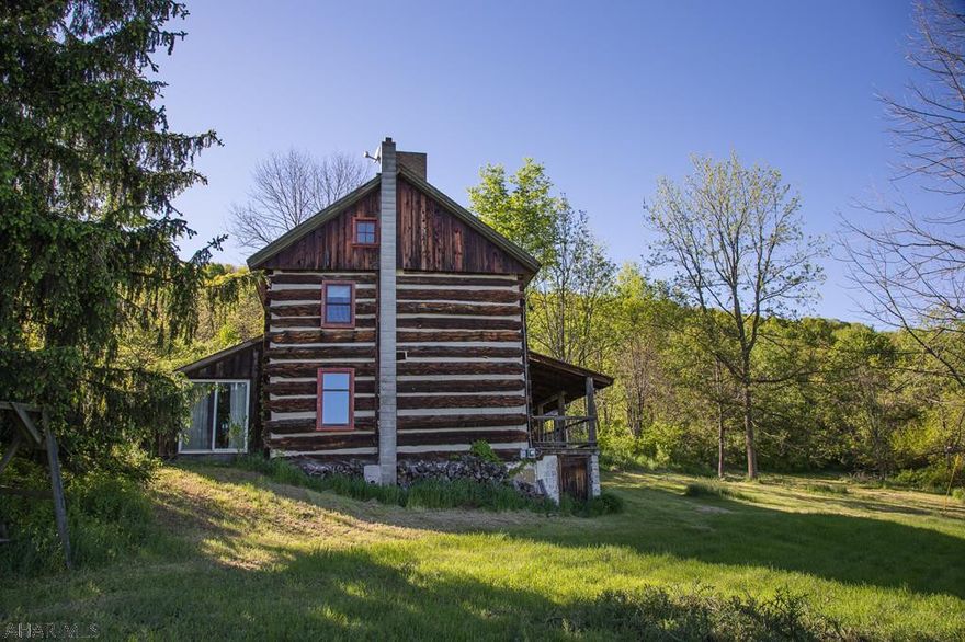 This is your chance to own a once in a lifetime property.  79.4 acres, with a restored log home with log work shop, and so much more.  Private hunting.  All of this with absolutely stunning views of the surrounding area.