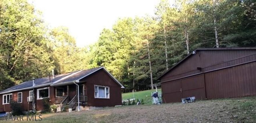 Charming 1 Bedroom 1 floor cottage or hunting camp on 2.032 acres on Lyleville Road near State Game Lands, located between Glendale Lake and Coalport. Near Prince Gallitzin State Park! Lovely grounds in quiet neighborhood; NOT part of Glendale Year Round. Large eat-in kitchen, public water, knotty pine interior, new T-111 siding, new thermopane windows (all but one), new wiring, large patio for entertaining.Large (20' by 52') garage/barn/workshop, shed for storage, & boat-themed garden. Motivated seller!