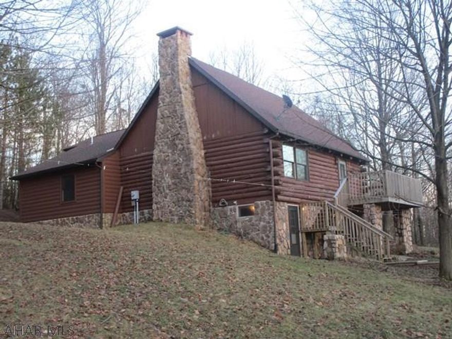 Big Price Reduction! An incredible setting for such a unique log home. Originally a 1 bedroom cabin. Truly an escape all while being in Hollidaysburg School District. Open Living area connected to Kitchen. Kitchen has Maple cabinets and Cherry stained Hickory Hardwood. So do the halls and 1 bath. Huge stone fireplace. Custom milled 7 inch tongue and grooved Pine wood walls on walls to match logs on outside  4 Bedrooms and an awesome loft that looks down on living room.  All this on 9.2 acres a stones throw from 7700+ acres of State game lands. Room for Parking RV or riding ATVs and entertaining. Great views and plenty of wildlife. Owner is a licensed PA REALTOR. County Assessed @ $225,000.00.  Needs a new septic.  Selling As Is Where Is. Call for more info or Showing. Motivated Sellers.