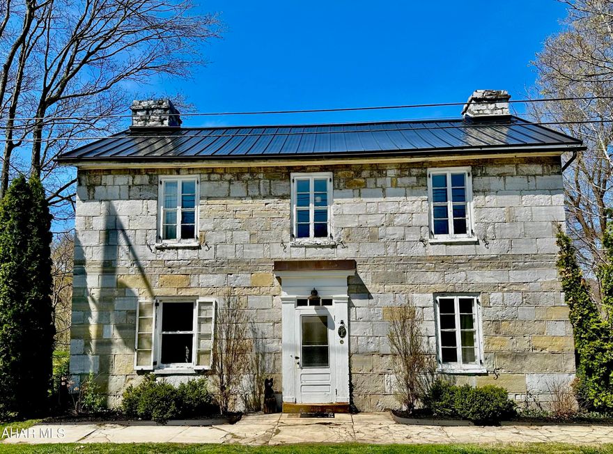 A rare opportunity to own a piece of history with this wonderful circa 1849 cut limestone home in Bedford County, PA.   Nestled on just over 7 flat acres with gorgeous mountain views and a small winding stream. There is plenty to do for the outdoor enthusiast, with two covered porches, raised beds, and several fruit trees including pear, gala and yellow delicious apple.   Inside the home much of the original charm remains with deep window sills, exposed stone accents, built-ins and original wood floors.   Three bedrooms plus a captive nursery on the second floor and a full bath on each floor.  New standing seam metal roof, fully rewired with 200 amp service, main level laundry and much more.   Give us a call today to make this wonderful home yours!