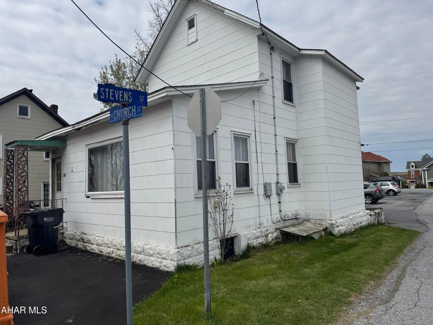 Asbestos sided two story home featuring 2 bedrooms, one bath, kitchen, dining and living room. Full unfinished basement with oil hw heat. The lot is small and is about what the house sits on.  Needs some tlc.