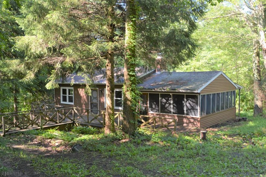 With a little bit of work this cabin in the woods could be your private getaway or primary residence. Located minutes from Buchanan State Forest and Pike 2 Bike. 16'x20' screened in porch would make a great place to entertain or kick back and relax. Recent updates include vinyl siding, windows, and water softener. Located less then 5 Minutes from PA Turn Pike and I-70. SOLD "AS-IS".