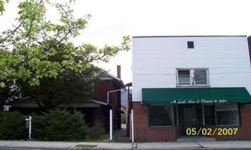 2 story brick, 3bdr, gas fireplace, original woodwork,  french doors, new electric service, large rooms. 2 story multi unit. All separate utilities. 3 apts plus 800 sq ft storefront with parking. Row of 8 garages with new metal roof.