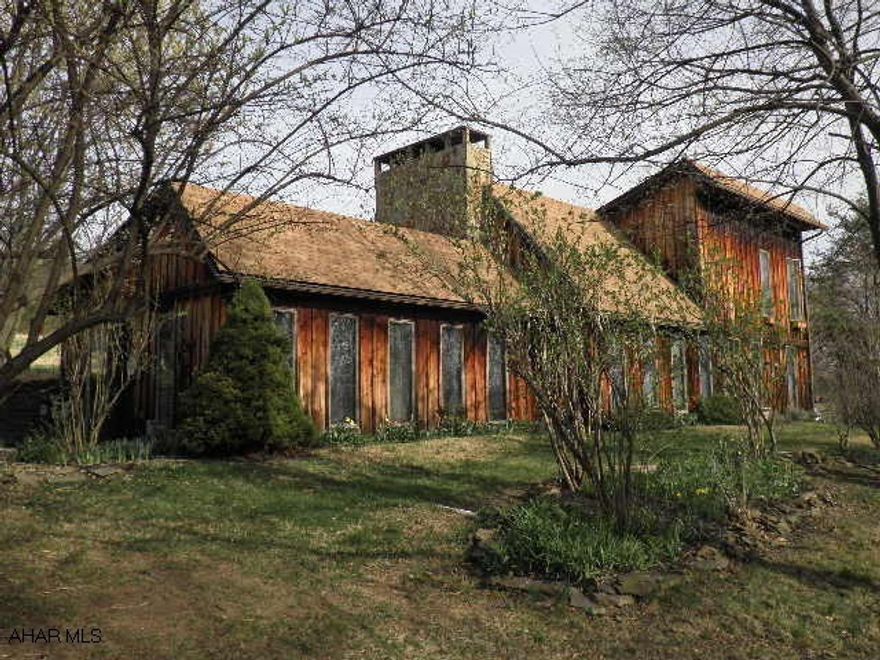 Unique home, private setting, 10.5 miles from heart of Bedford with charming features. 7.46 acres. A new roof is going to be put on the house, the workshop, and the outbuilding.