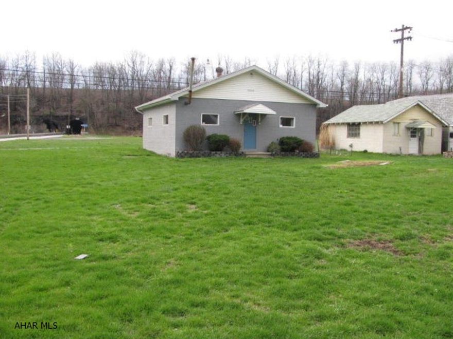 Large level vacant lot with over sized 2 car block garage w/new roof! Garage with pit. Wood furnace & 100 amp electric service. Perfect for working on your vehicles or storage!