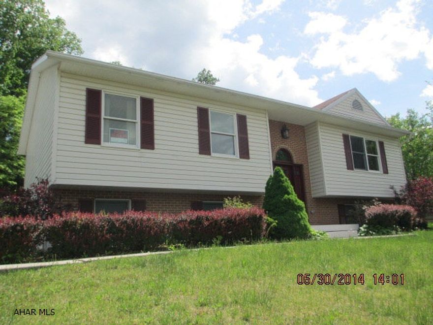 Beautiful Bi-level with Vaulted Ceilings, Skylights.  House in Move-in condition. 3 Bedroom 3 baths.  Family room in basement. Large 2 car garage. Nice private covered deck.  Woods behind property. Kitchen has island.Well Water. Sewer $53.00 month. Electric $159.00 Equalized payment.