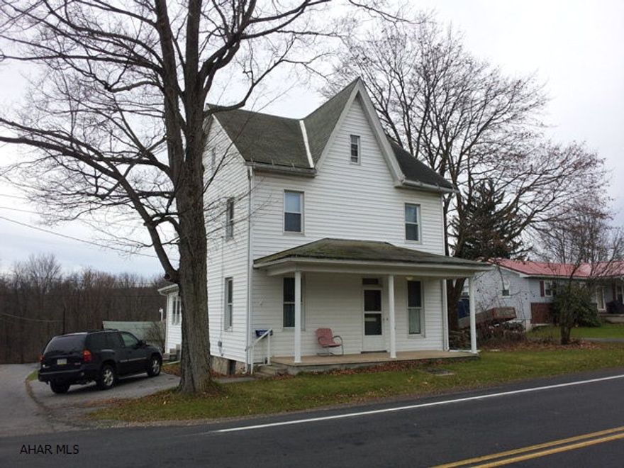 2 1/2 story, 3 bedroom home on corner lot. Enclosed rear porch. 1 car detached garage.