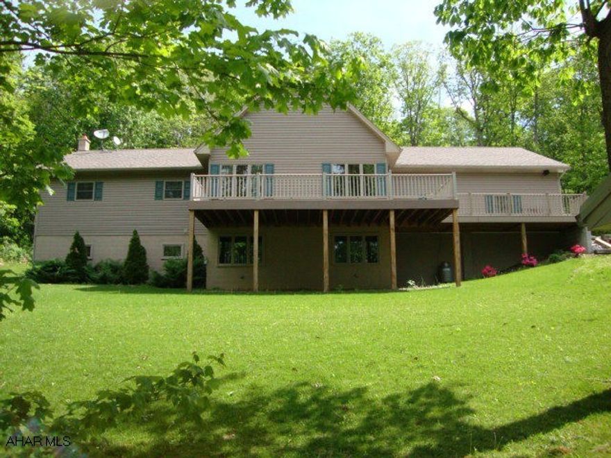 Get back to nature in this 4 Bedroom, 3 Bath, one level home nestled in the woods on 3 acres in a private setting. Oil hot water heat with radiant heat in great room, kitchen and dinig room.  Large open floor plan with wood cathedral ceilings with skylights. Floor to ceiling stone gas fireplace. Large front deck,rear covered porch,  finished basement with family room, bedroom and full bath. Large pavillion for entertaining. Storage shed.  Contractor built and owned. SELLER IS RELATED TO LISTING AGENT.