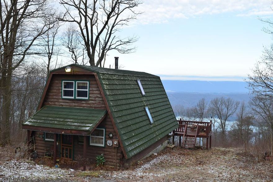 **WATER VIEW** Looking for a Raystown Lake Cabin with acreage, a year round view of the lake, adjacent to state game lands? Well this is the perfect place then! This home is 1 1/2 stories, with an open floor plan with a large kitchen, living room, and completely remodeled sanctuary of a bathroom on the first floor. Second floor features two lofted bedrooms. The master bedroom features an amazing covered deck with a year round view of Raystown Lake. Directly across from seven points, this year round access cabin would be the perfect destination for a getaway personally or as a vacation rental.