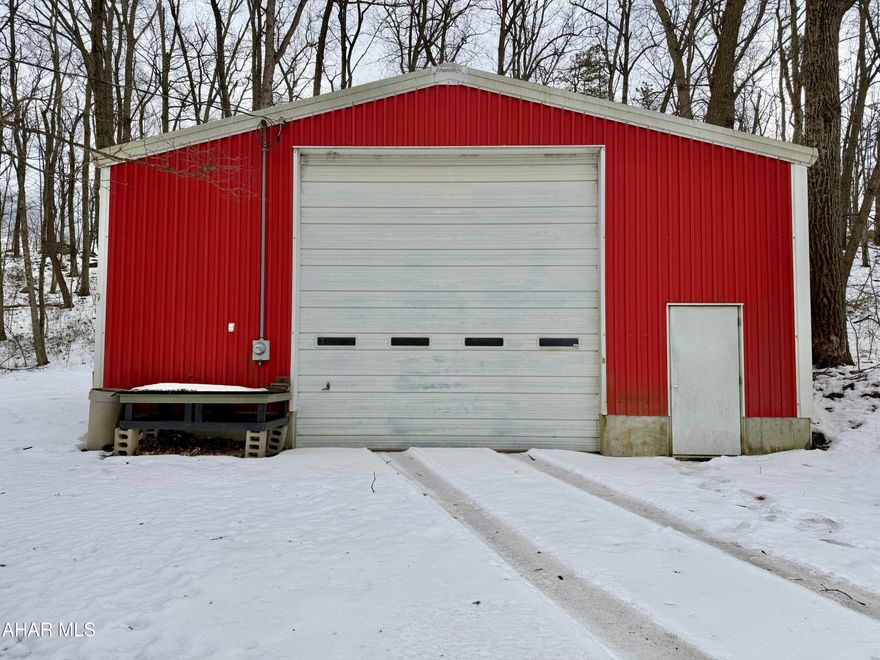 32'x57' garage featuring a 14'x14' overhead door, a 16' high ceiling in the center, concrete floor, electric, and an oil-forced air furnace. This property would make a great place to open that small business that you've wanted to start or ample space to store and work on your hobbies. Also included in the sale is a rented mobile home, offering extra income or living space. AS-IS sale. Seller will make no repairs.