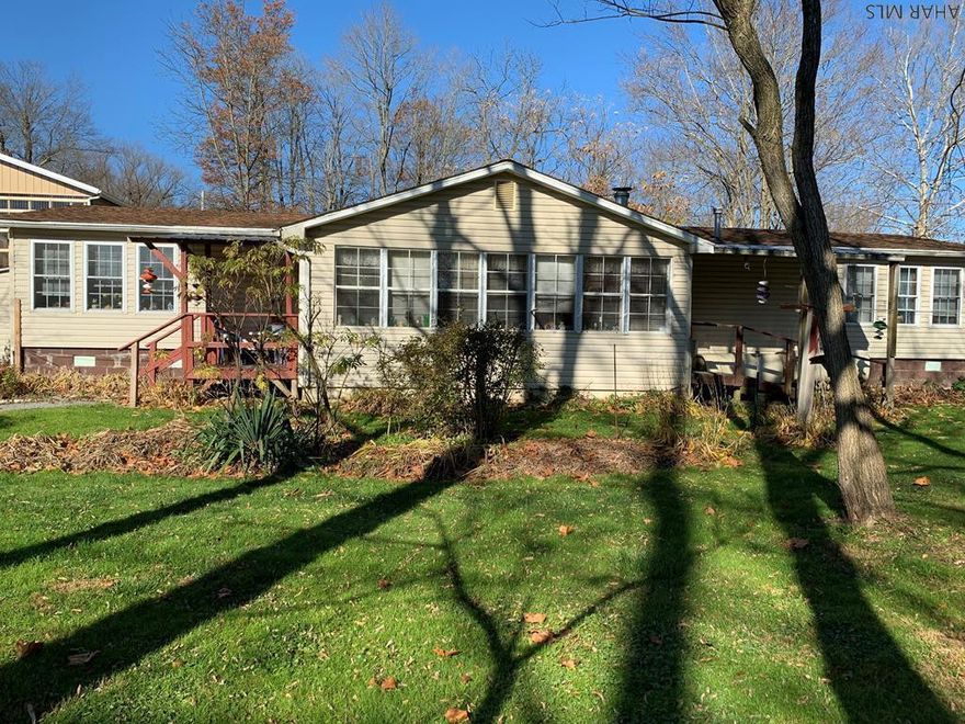 Located in Camp Wayside area.  Spacious home:  3 BR, 2 full baths. - Jacuzzi tub in one bathroom.    Screen porch ( weather Covering can be added/ removed easily.)   3 storage buildings PLUS a 3 car detached garage.  A  VERY spacious garage/storage area with a vehicle lift included for that DIY mechanic.  That garage utilizes a lot of outdoor natural lighting by virtue of it's design.  There are also 2 other storage buildings (cottage type) plus a covered picnic pavilion with an outdoor fireplace inside of it.  Camera security system will convey with the property. Outside generator system conveys.  This property has SO much to offer and endless possibilities.  Could be "home sweet home" or a great weekend getaway.  Either way, you need to check this one out !