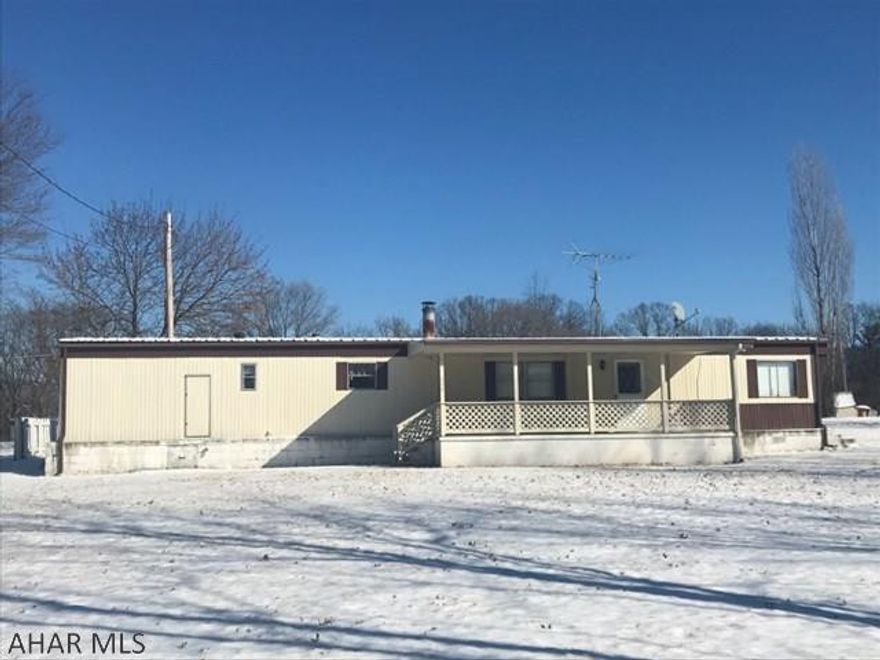 Three bedroom, one and a half bath single wide on large flat lot. Home is 14'x66'. One car garage and an additional shed. Paved driveway and large covered porch. Interior has newer carpet and newer kitchen cabinets. New 200 amp electrical system. House has been well maintained. Forced air heat and central AC. Wheelchair accessible. Living room is spacious and features a wood burning fire place. Yard is just shy of an acre and is large, flat and private! Close to main roads but quiet country feel. Set up your showing today!