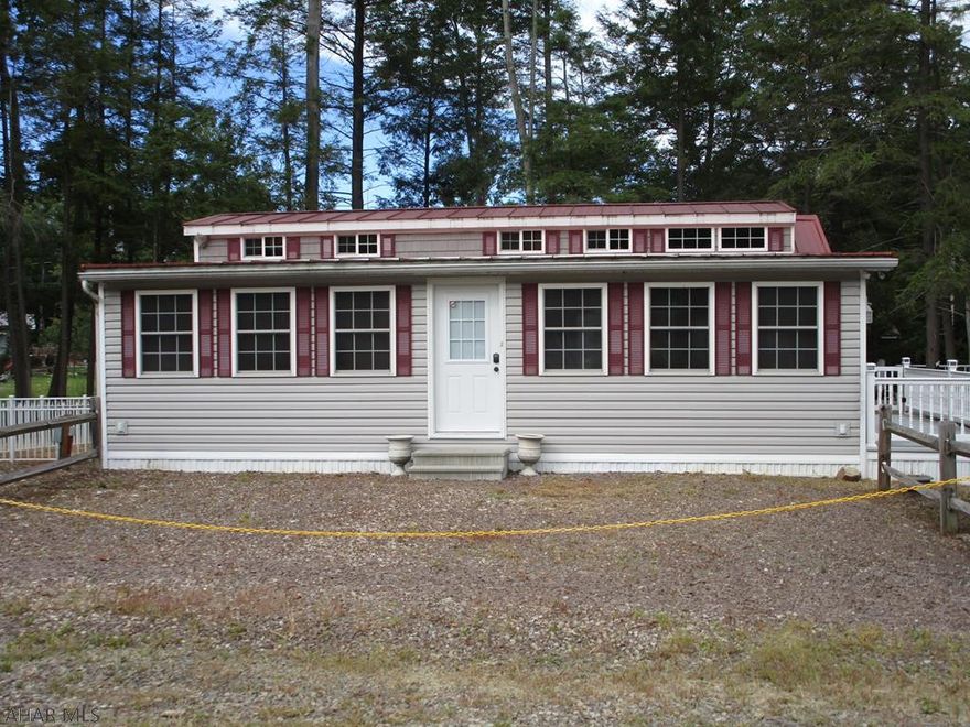 Upscale park model with second level and 12' x 33' addition will have your non-camping friends visiting.  You Need to see this property to appreciate all it has to offer.  The double lot presents outdoor options from a deck, fenced in yard, playhouse, and shed.  Inside is so spacious you will have room for the whole family to each have their own space.  Nice enough to live in, you will want to spend all of your free time in this gorgeous getaway.  Heat and air conditioning are supplied by a heat pump.  Two fireplaces add an elegant homey feeling. One bedroom downstairs and on the second floor are two queens and room for more.  Window air conditioner upstairs for added comfort.  Located in Glendale Yearound, a gated community adjacent to Prince Gallitzin State Park/Glendale Lake.