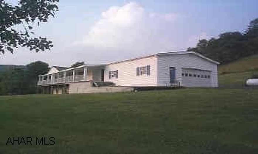 Doublewide w/ breezeway & 2 car attached garage well maintained property with a peaceful view, all new doors, windows & heating system