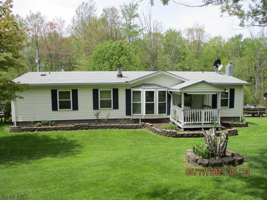 One story living on 1.75 partially wooded  acres adjacent to State Game Lands. Living room with wood burning fireplace. Oak kitchen cabinets, appliances stay. Laundry room off kitchen with washer & dryer included. Master bedroom with large closet and master bath with garden tub, shower & vanity area. Den/office or bonus room with sliding doors to the deck. Lots of perennials and mature trees on this property. Sit on the back deck and watch the wildlife. Full basement offers a 2 car garage and plenty of storage. Shed and carport/garage add extra storage for the extra vehicles, 4 wheelers or boats. Newer roof & windows.  If you are looking for a property in the country yet close to town this is it!