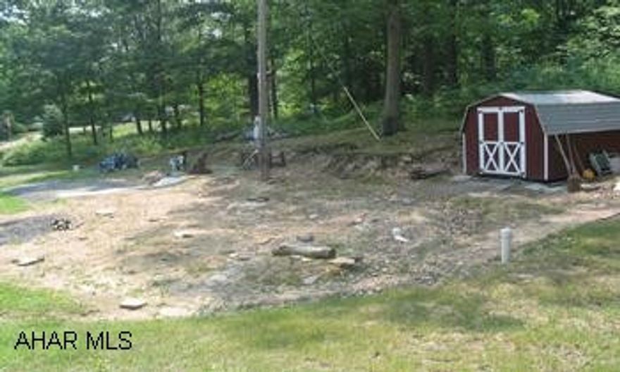 Thinking of building a new home? Take a look at this pretty 5 acre lot. Well & septic, mostly wooded & semi private.