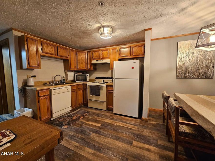 This spacious 2-bedroom, 2-bath condo for sale is the perfect retreat for outdoor enthusiasts and those seeking comfort and relaxation. Located just minutes from the renowned Blue Knob Ski Resort, this property offers easy access to skiing and snowboarding in the winter and hiking and mountain biking during the warmer months. The cozy living room features a fireplace, perfect for relaxing after a day on the slopes. The kitchen is well-equipped with all that you need for a weekend getaway!
The master bedroom features an en-suite bathroom, while the second bedroom offers plenty of space and access to the second full bathroom. Both bedrooms are designed for comfort and relaxation, with luxury vinyl flooring throughout the entire condo.
The condo also includes access to luxurious amenities like an indoor pool, a hot tub, and an outdoor swimming pool and much more! Whether you want to unwind after a busy day or take a dip to cool off in the summer, these facilities provide the ultimate in relaxation.
This condo is an ideal mountain getaway, blending convenience and comfort with the beauty of nature. Perfect for year-round enjoyment, it's an excellent choice for those seeking a vacation home or a long-term investment in the heart of ski resort country.