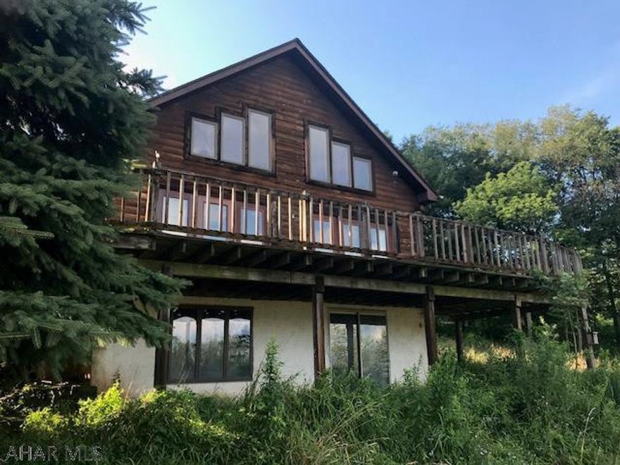 Enjoy the spectacular view of Dry Run  from the front of this 1 1/2 story log home.  Customized by the original owner.  This home has tons of potential.  Nice oak kitchen cabinets.  Big bath with soaking tub.  House is in need of TLC.  House Inspection on file.  AS IS SALE.  Use caution on stairs and decks.  Seller requires 5 days in mls before they will respond to offers.