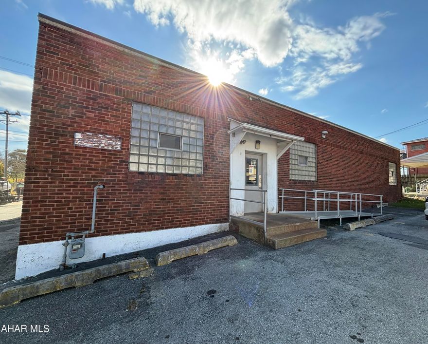 Spacious Multi-Use Brick Property in High-Traffic Area. This expansive brick commercial building, located at 2801-03 Beale Avenue in the bustling city of Altoona, PA, offers a range of versatile spaces suited for a variety of business needs. Covering a total area of 3,685 interior square feet, this property is
situated in a high-traffic area, making it an attractive choice for business owners looking for optimal
visibility and accessibility.
Inside, the building features several well-defined rooms, including a large open workshop ideal for craftspeople or those in need of a generous workspace. The facility also includes two bathrooms, both handicap accessible, providing practical amenities for both employees and clients. An office room is included within the structure, offering a private space for administrative tasks or
meetings. There are three additional storage rooms, providing abundant space for inventory, supplies, or equipment. A highlight of the property is the loading dock, which comes equipped with a spacious 12x13 foot garage door, streamlining the process of receiving and dispatching goods. For businesses that require parking, the property offers space for 8 to 10 vehicles, ensuring  convenience for staff and visiting clients alike. The surrounding area of Beale Avenue is characterized by its commercial activity, offering a dynamic
neighborhood vibe with a strong presence of local businesses. Transportation options in Altoona are
plentiful, with easy access to major roads and public transit routes, making this location an ideal choice for businesses that depend on foot traffic or a steady flow of customers. Overall, this property presents a realistic opportunity for business owners seeking a versatile and
functional space in a prime Altoona location.