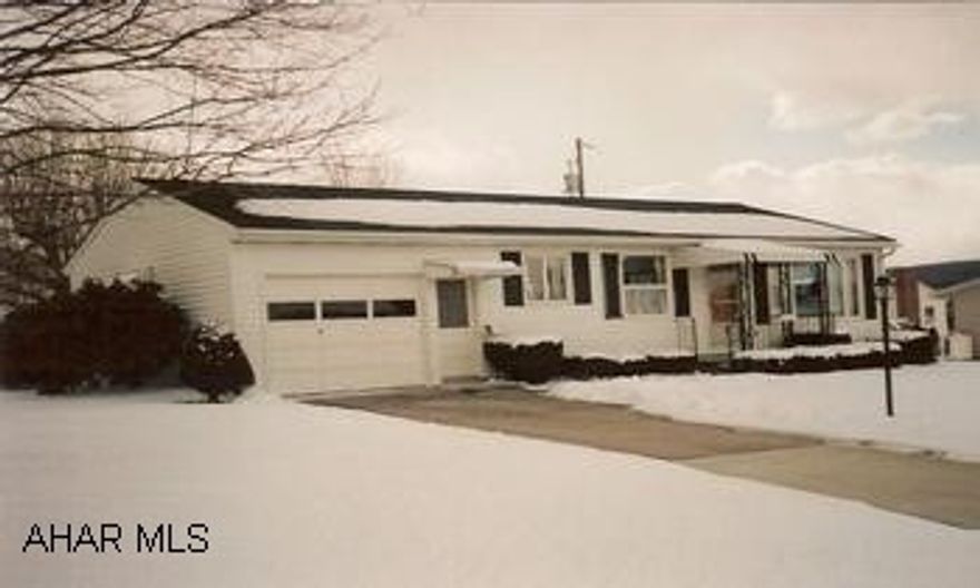 Well kept cozy home with natural woodwork . Beautiful hardwood floors under carpeting. Eat-in kitchen includes pantry and pretty corner cabinet. Quiet street. Full basement has finished bonus room. Large yard. One-car attached garage and a one-car detached garage. Includes range and refrigerator.