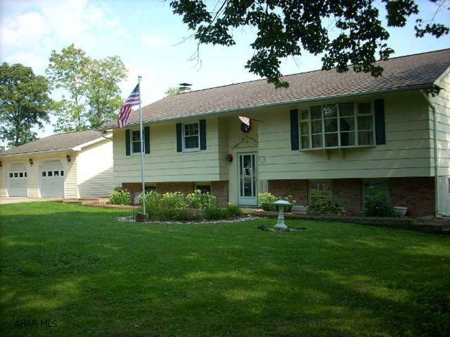 Beautiful bi-level in Tipton.  Private setting, spacious home with lots of storage.  2 car detached garage, green house, storage shed, covered porch with great view of the mountains, finished family & game rooms with woodburner.  Paved driveway, newer windows, updated mechanics.  Renovated kitchen and much, much more!!