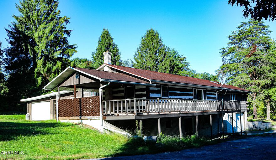 Are you ready to Fall in love with 332 Heckman Road?  Lovely log home located in Hopewell on 1.43 ac. with 3 bedrooms and 2 full baths.  Large living room, spacious kitchen, and dining room with skylights for all that natural light.  Entertain inside or out and enjoy the views on your wrap around deck.  Half the deck covered.  Private driveway with plenty of parking and garages. Full basement to make your own!  Private well and public sewer.  Solar panels too!!  Tussey Moutain School District.   Let's make this happy home yours today!