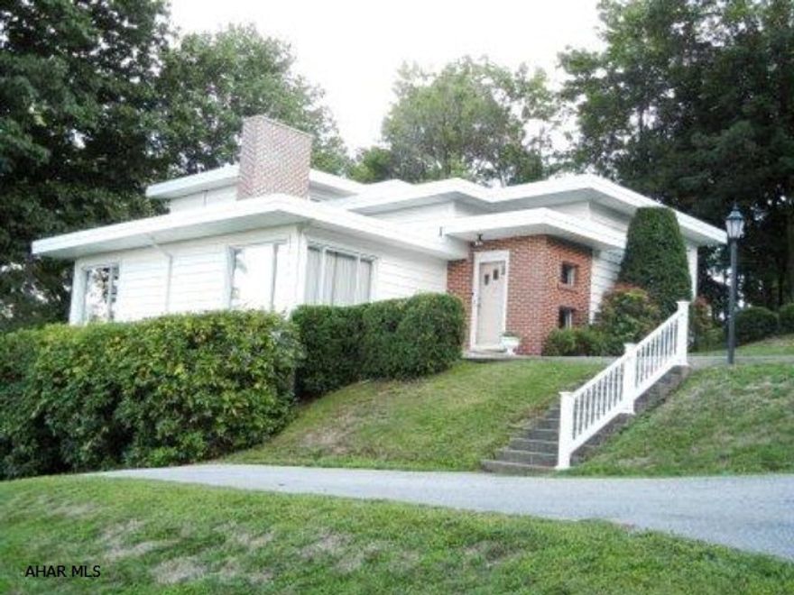 Frank Loyd Wright inspired, mountain views from every room, multiple driveways, hardwood under carpet, covered patio used as carport in winter, storage abound.  Almost 1/2 acre. Commercial rubber roof in 2001. Newer windows,furnace, AC, hot water heater & electric. Owner is a licensed Realtor.