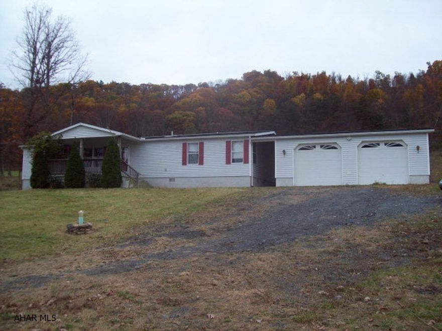 3 bedroom, 2 bath dblwide on full foundation with small breezeway and oversized 2car garage on 1 acre.  Private setting.